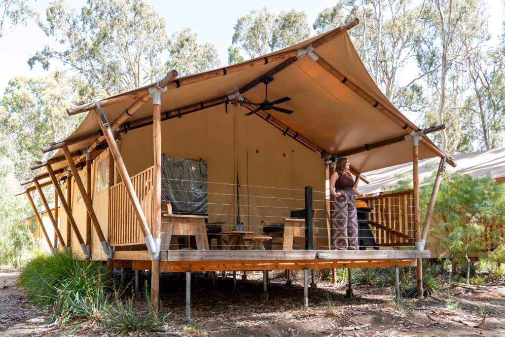 Girl looking into nature on glamping tent deck